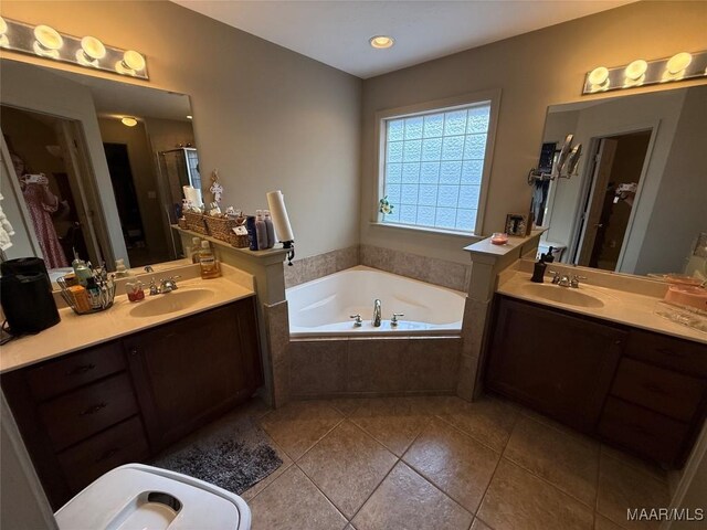 3701 Claiborne Cir, Montgomery, AL 36116 - bathroom with tile patterned flooring, a garden tub, a shower stall, and two vanities