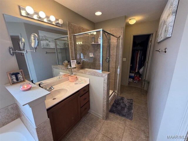 3701 Claiborne Cir, Montgomery, AL 36116 - full bath with vanity, a stall shower, tile patterned flooring, and a spacious closet