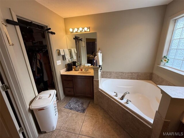 3701 Claiborne Cir, Montgomery, AL 36116 - full bathroom featuring a garden tub, vanity, tile patterned floors, and a walk in closet
