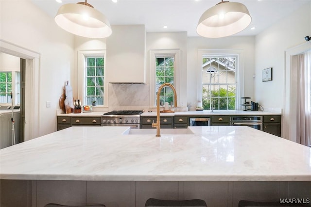 3328 Lebron Rd, Montgomery, AL 36106 - kitchen with washing machine and clothes dryer, stainless steel appliances, light stone counters, healthy amount of natural light, and recessed lighting