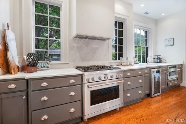 3328 Lebron Rd, Montgomery, AL 36106 - kitchen with appliances with stainless steel finishes, gray cabinets, custom exhaust hood, beverage cooler, and recessed lighting