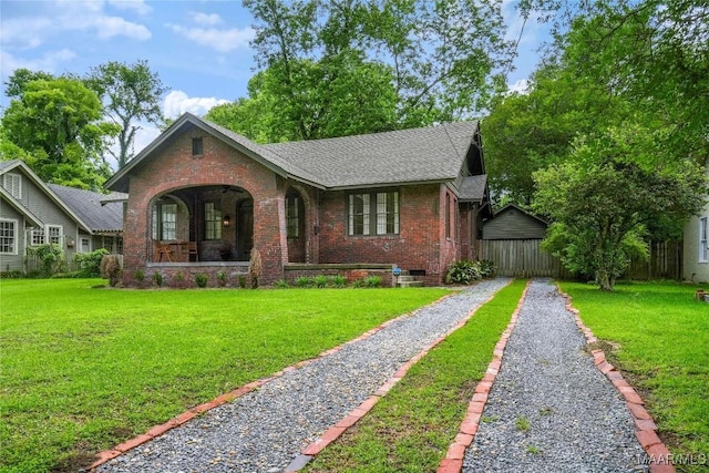 3328 Lebron Rd, Montgomery, AL 36106 - view of front of property with brick siding, covered porch, and a front yard