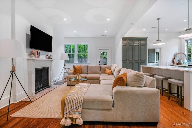 3328 Lebron Rd, Montgomery, AL 36106 - living room with healthy amount of natural light, light wood-style flooring, a fireplace, and recessed lighting