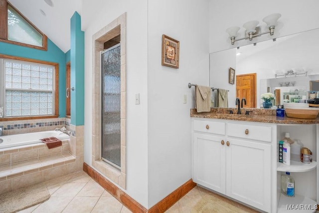 258 S Conecuh St, Greenville, AL 36037 - full bath featuring lofted ceiling, tile patterned flooring, a shower stall, a bath, and vanity