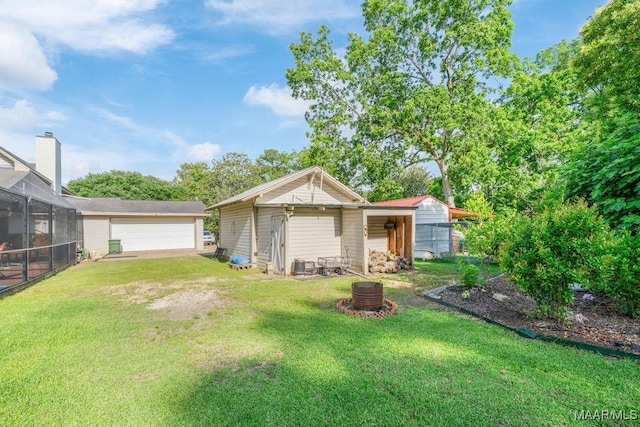 258 S Conecuh St, Greenville, AL 36037 - rear view of property with a lawn, a detached garage, and an outbuilding