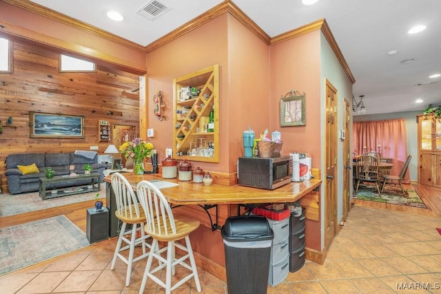 258 S Conecuh St, Greenville, AL 36037 - bar area with stainless steel microwave, crown molding, tile patterned flooring, recessed lighting, and wood walls