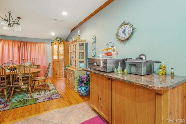258 S Conecuh St, Greenville, AL 36037 - kitchen with light tile patterned floors, ornamental molding, vaulted ceiling, and recessed lighting