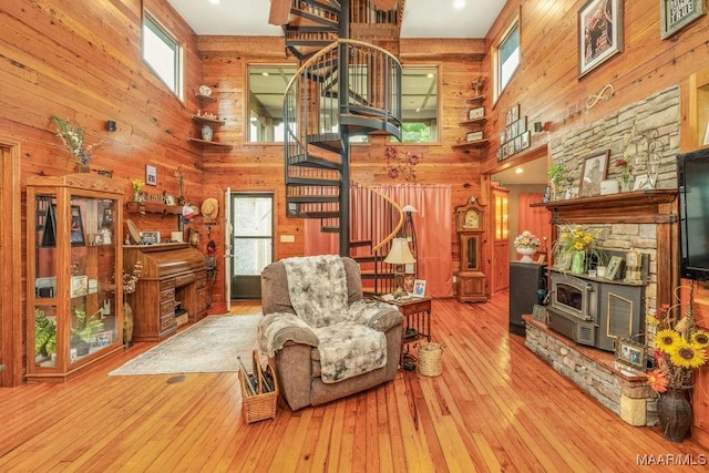 258 S Conecuh St, Greenville, AL 36037 - living area featuring a high ceiling, wood walls, stairs, wood-type flooring, and a wood stove
