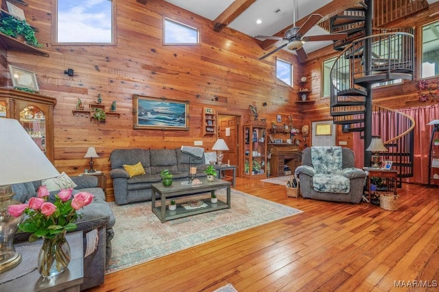 258 S Conecuh St, Greenville, AL 36037 - living area with a high ceiling, wooden walls, stairs, a ceiling fan, and hardwood / wood-style floors