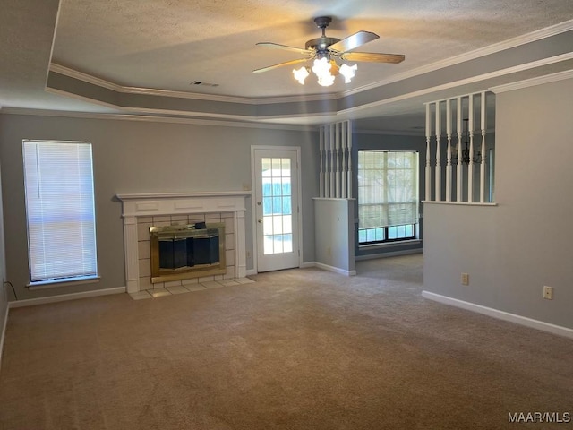 1853 Sanford Dr, Prattville, AL 36066 - unfurnished living room featuring a fireplace, ornamental molding, a tray ceiling, ceiling fan, and baseboards