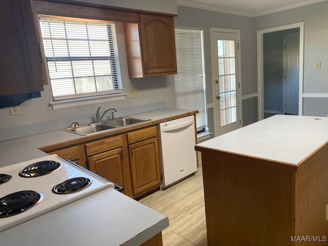 1853 Sanford Dr, Prattville, AL 36066 - kitchen featuring white appliances, a sink, ornamental molding, light countertops, and brown cabinetry