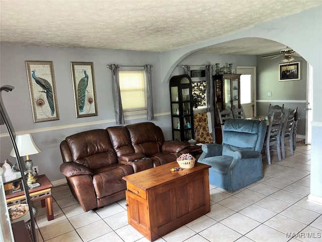 3740 Martha Ln, Millbrook, AL 36054 - living area featuring arched walkways, light tile patterned floors, a textured ceiling, and ceiling fan