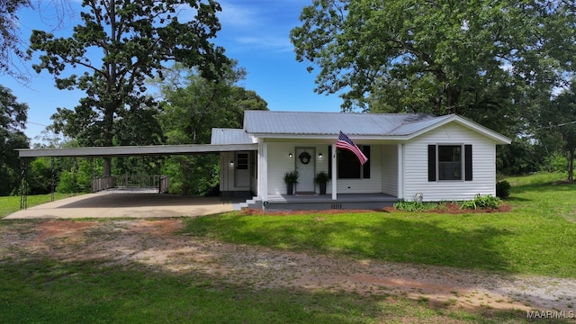 1582 W Old Hayneville Rd, Le Grand, AL 36105 - view of front of home featuring covered porch, driveway, a front lawn, a carport, and metal roof