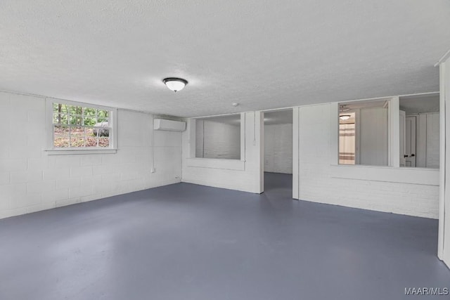 1582 W Old Hayneville Rd, Le Grand, AL 36105 - below grade area featuring an AC wall unit, a textured ceiling, and concrete block wall