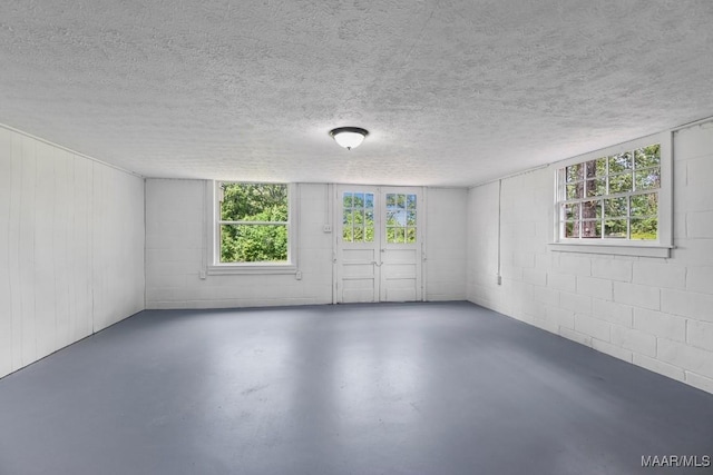 1582 W Old Hayneville Rd, Le Grand, AL 36105 - empty room with concrete floors, concrete block wall, and a textured ceiling