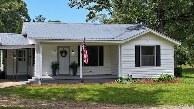 1582 W Old Hayneville Rd, Le Grand, AL 36105 - view of front of property featuring covered porch, a carport, a front yard, and metal roof