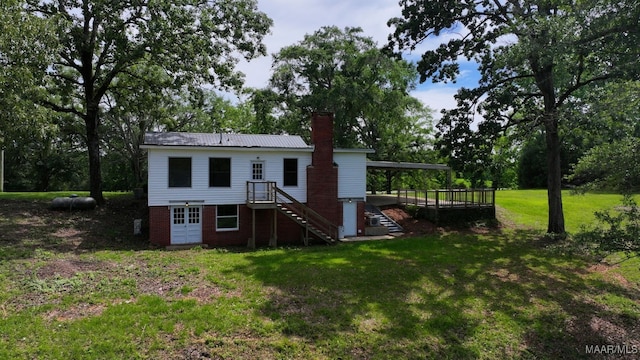 1582 W Old Hayneville Rd, Le Grand, AL 36105 - back of house with a chimney, a lawn, stairs, and view of scattered trees