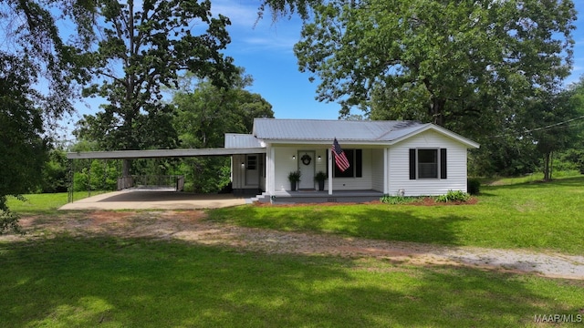 1582 W Old Hayneville Rd, Le Grand, AL 36105 - view of front of house featuring driveway, a porch, a carport, a front lawn, and metal roof