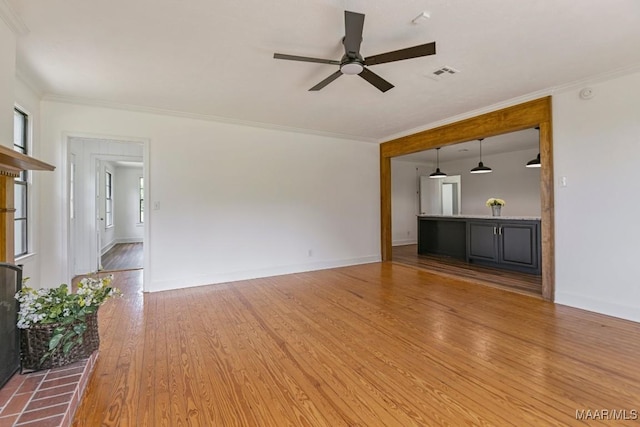 1582 W Old Hayneville Rd, Le Grand, AL 36105 - unfurnished living room featuring a ceiling fan, wood finished floors, crown molding, and baseboards