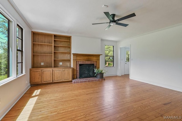 1582 W Old Hayneville Rd, Le Grand, AL 36105 - unfurnished living room featuring light wood-style flooring, a brick fireplace, baseboards, ceiling fan, and crown molding