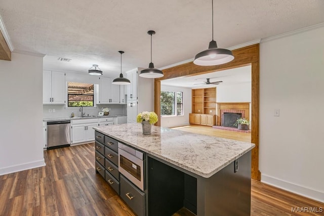 1582 W Old Hayneville Rd, Le Grand, AL 36105 - kitchen featuring appliances with stainless steel finishes, a sink, ornamental molding, white cabinetry, and dark wood-type flooring