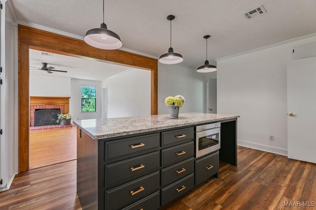 1582 W Old Hayneville Rd, Le Grand, AL 36105 - kitchen featuring a brick fireplace, ornamental molding, ceiling fan, dark wood-type flooring, and pendant lighting