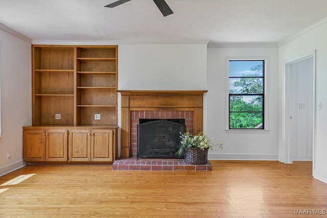 1582 W Old Hayneville Rd, Le Grand, AL 36105 - unfurnished living room with ornamental molding, light wood finished floors, a ceiling fan, a brick fireplace, and baseboards
