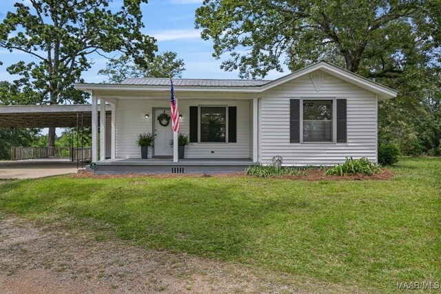 1582 W Old Hayneville Rd, Le Grand, AL 36105 - single story home featuring covered porch, a front yard, a carport, driveway, and metal roof