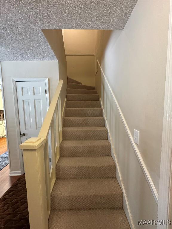 215 W Castlewood Dr, Selma, AL 36701 - stairs featuring a textured ceiling and wood finished floors