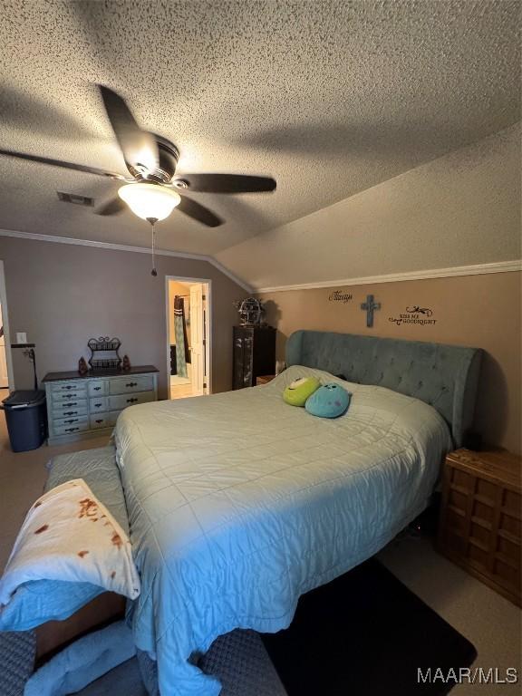 215 W Castlewood Dr, Selma, AL 36701 - bedroom featuring a textured ceiling, lofted ceiling, ceiling fan, ornamental molding, and carpet floors