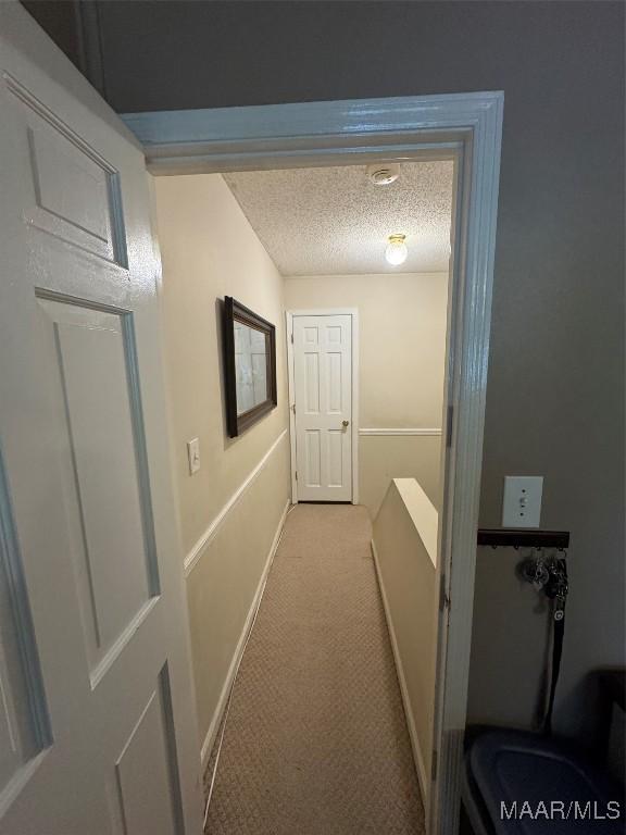 215 W Castlewood Dr, Selma, AL 36701 - hall featuring a textured ceiling, carpet, and baseboards