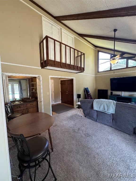 215 W Castlewood Dr, Selma, AL 36701 - carpeted living room featuring plenty of natural light, beamed ceiling, a ceiling fan, a textured ceiling, and a sink