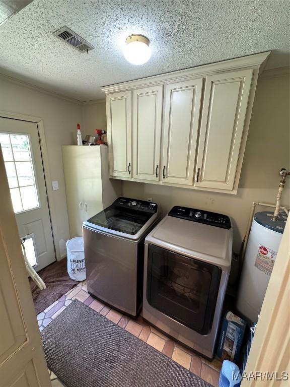 215 W Castlewood Dr, Selma, AL 36701 - washroom featuring separate washer and dryer, cabinet space, water heater, and a textured ceiling