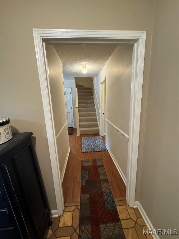 215 W Castlewood Dr, Selma, AL 36701 - corridor with baseboards, light wood finished floors, and a textured ceiling