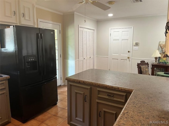11 Wilkins Rd, Selma, AL 36701 - kitchen with black refrigerator with ice dispenser, a ceiling fan, crown molding, light tile patterned flooring, and dark countertops