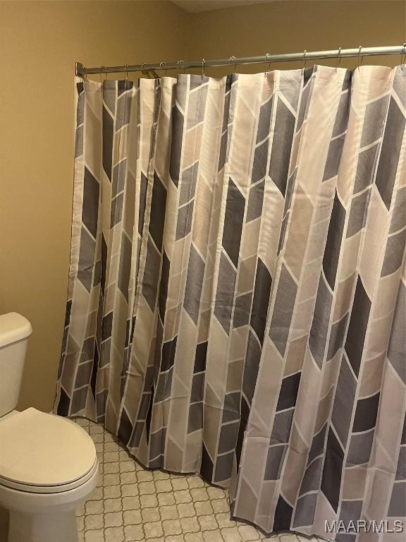 11 Wilkins Rd, Selma, AL 36701 - bathroom featuring toilet and curtained shower