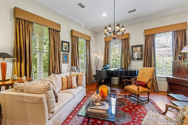 1533 Gilmer Ave, Montgomery, AL 36104 - living area with a chandelier, healthy amount of natural light, wood finished floors, crown molding, and recessed lighting