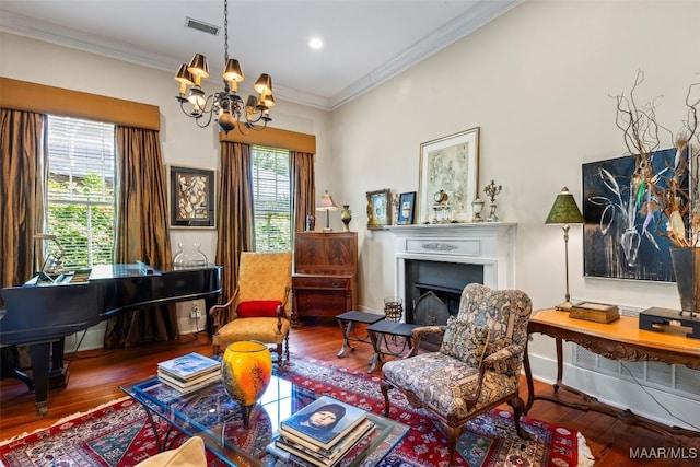 1533 Gilmer Ave, Montgomery, AL 36104 - sitting room featuring wood finished floors, a chandelier, a fireplace, ornamental molding, and recessed lighting