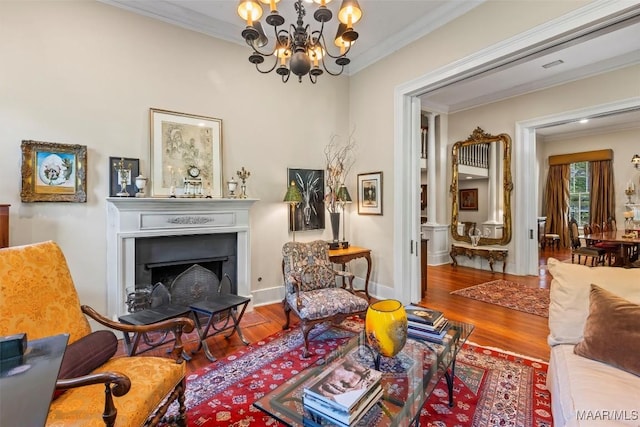1533 Gilmer Ave, Montgomery, AL 36104 - sitting room featuring crown molding, a chandelier, wood finished floors, a fireplace, and baseboards