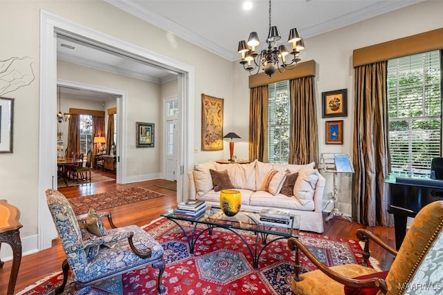 1533 Gilmer Ave, Montgomery, AL 36104 - living room featuring a chandelier, wood finished floors, plenty of natural light, ornamental molding, and baseboards