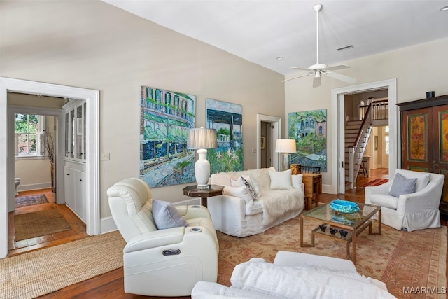1533 Gilmer Ave, Montgomery, AL 36104 - living room featuring stairs, wood finished floors, a ceiling fan, and baseboards