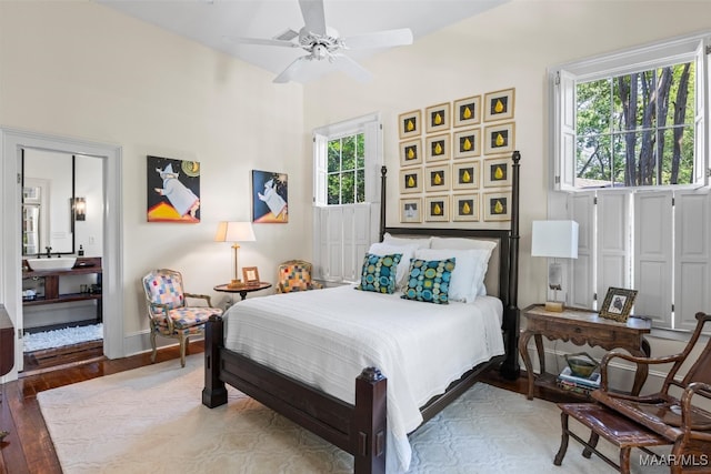 1533 Gilmer Ave, Montgomery, AL 36104 - bedroom with multiple windows, wood finished floors, a sink, and baseboards