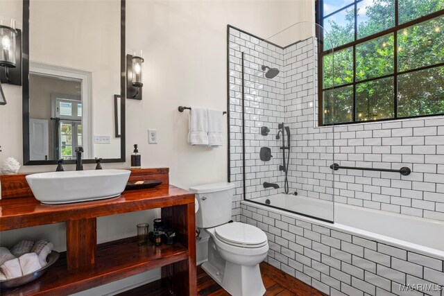 1533 Gilmer Ave, Montgomery, AL 36104 - bathroom featuring plenty of natural light, toilet, tiled shower / bath, and vanity