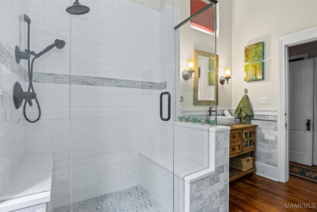 1533 Gilmer Ave, Montgomery, AL 36104 - full bathroom featuring a stall shower, vanity, wainscoting, and wood finished floors