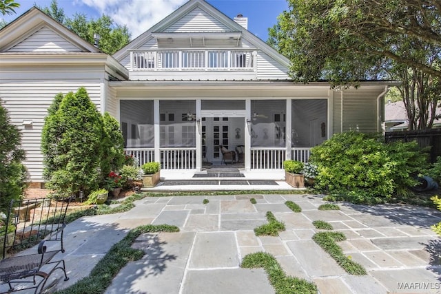 1533 Gilmer Ave, Montgomery, AL 36104 - back of house featuring a balcony, a sunroom, a chimney, and a patio area
