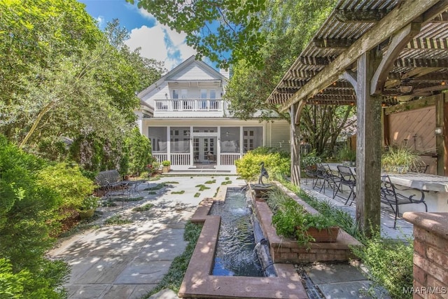 1533 Gilmer Ave, Montgomery, AL 36104 - back of property with french doors, a patio, a sunroom, a pergola, and a balcony