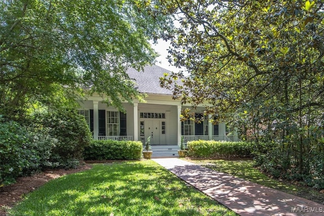 1533 Gilmer Ave, Montgomery, AL 36104 - obstructed view of property featuring covered porch, a front lawn, and a shingled roof