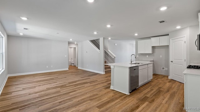 6008 Cunningham Trl, Montgomery, AL 36116 - kitchen with dishwasher, a sink, light wood-style floors, open floor plan, and recessed lighting