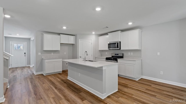 6008 Cunningham Trl, Montgomery, AL 36116 - kitchen featuring appliances with stainless steel finishes, a sink, wood finished floors, light countertops, and recessed lighting