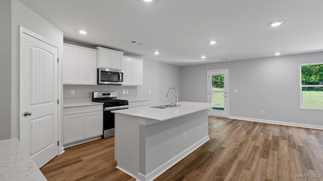 6008 Cunningham Trl, Montgomery, AL 36116 - kitchen featuring a sink, appliances with stainless steel finishes, wood finished floors, recessed lighting, and white cabinets